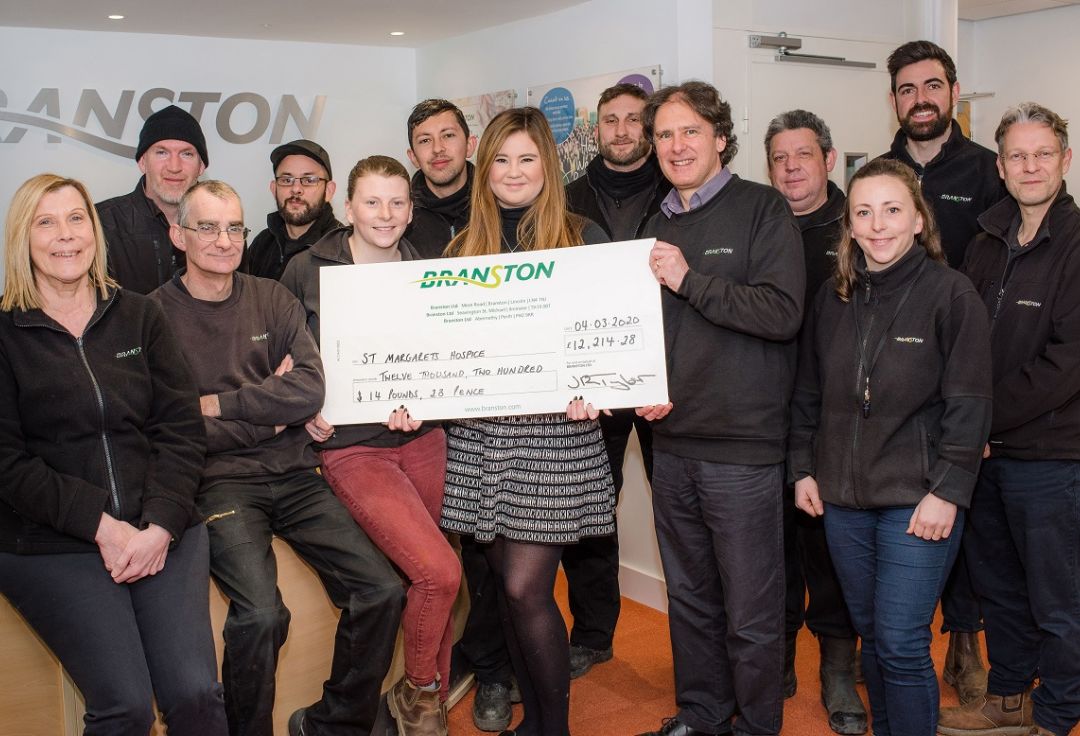 Branston’s South West team presents their 2019 fundraising total to St Margaret’s
